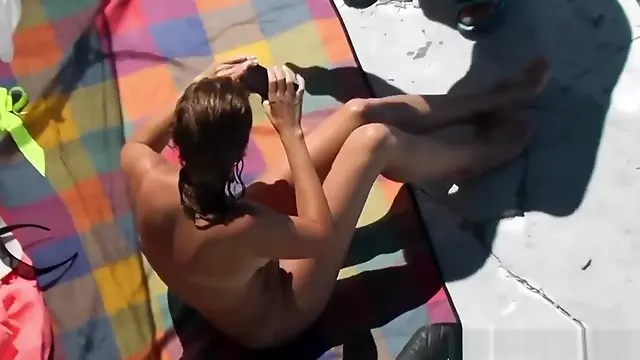 Jerking off her boyfriend in shallow waters
