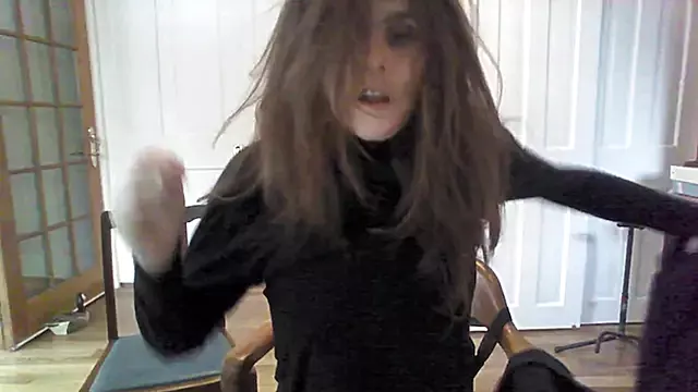 Transgender amateur strips off layers while teasingly warming chilly feet.