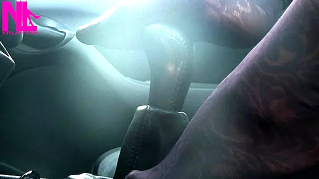 Caressing and footplaying with the wheel and the shift stick in violet patterned pantyhose
