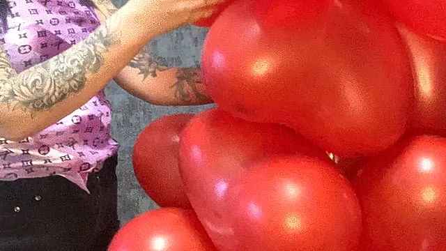 nail poping heart balloons