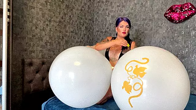 Looner Val poping big white balloons