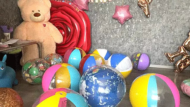 sit on beachball and poping balloons